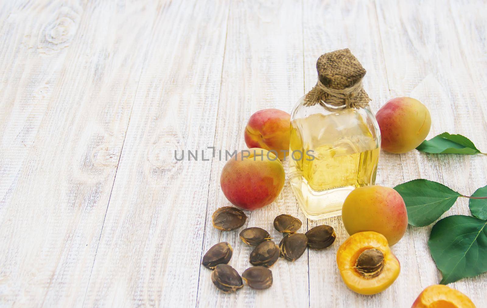 apricot oil in a small jar. selective focus. by yanadjana