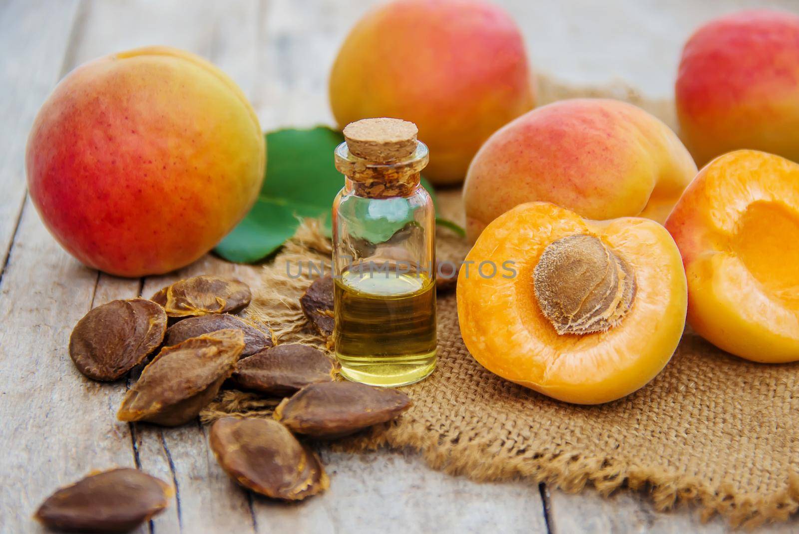 apricot oil in a small jar. selective focus. by yanadjana