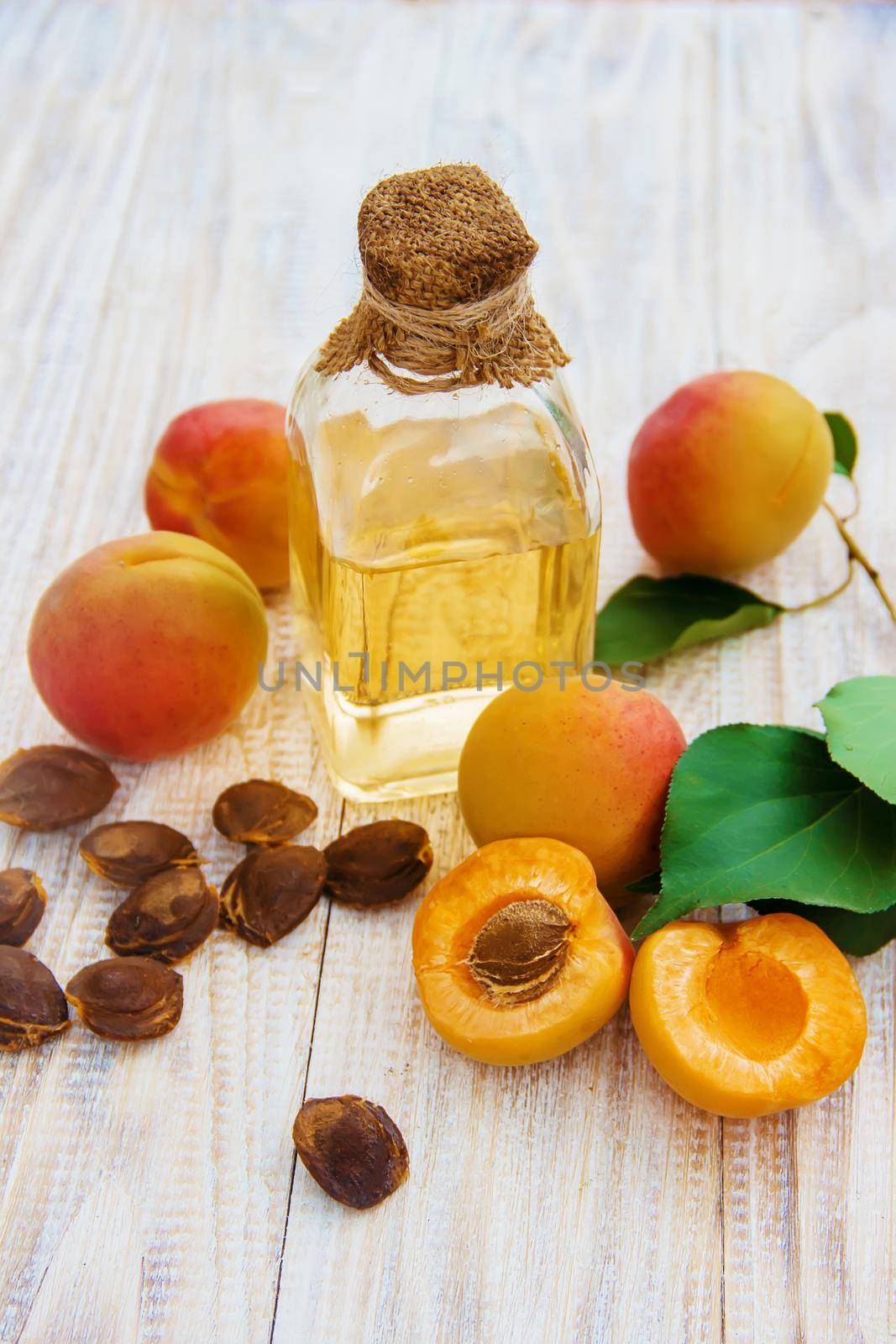 apricot oil in a small jar. selective focus. by yanadjana