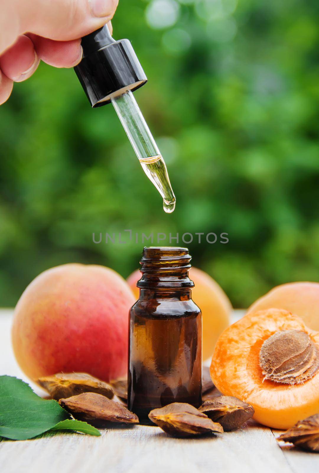 apricot oil in a small jar. selective focus. by yanadjana