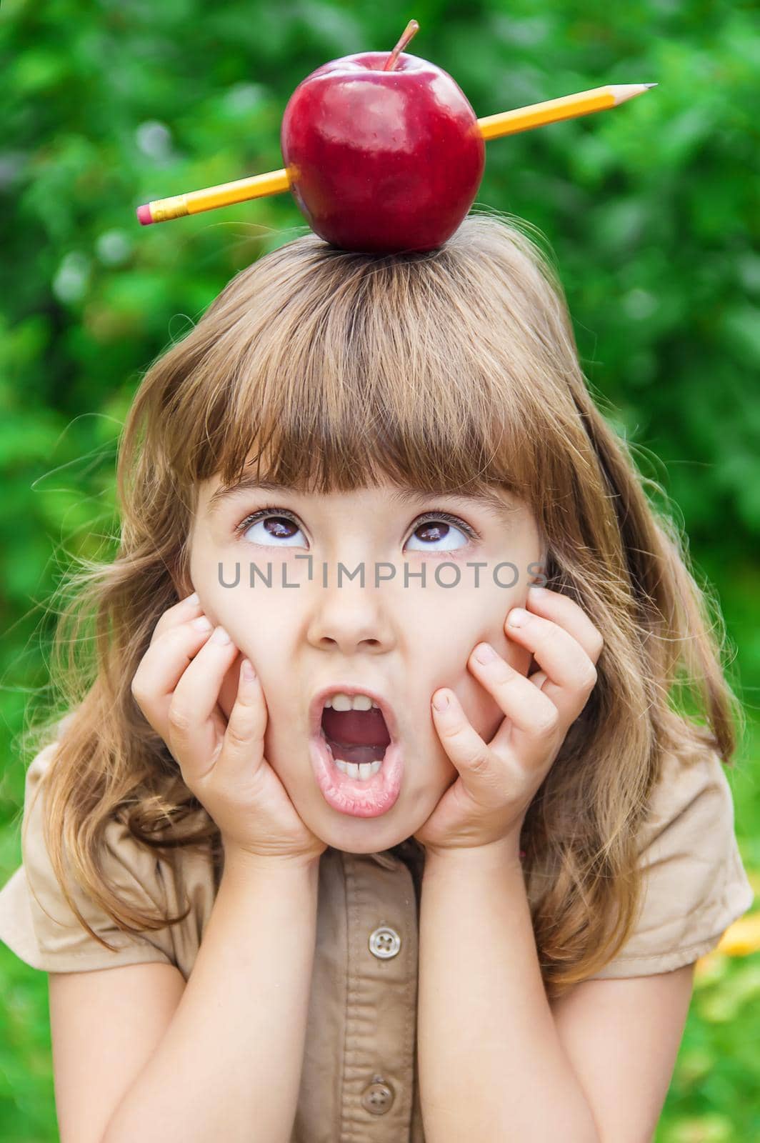 Child student with a red apple. Selective focus. nature.