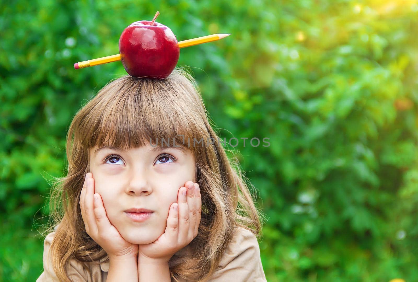 Child student with a red apple. Selective focus. by yanadjana