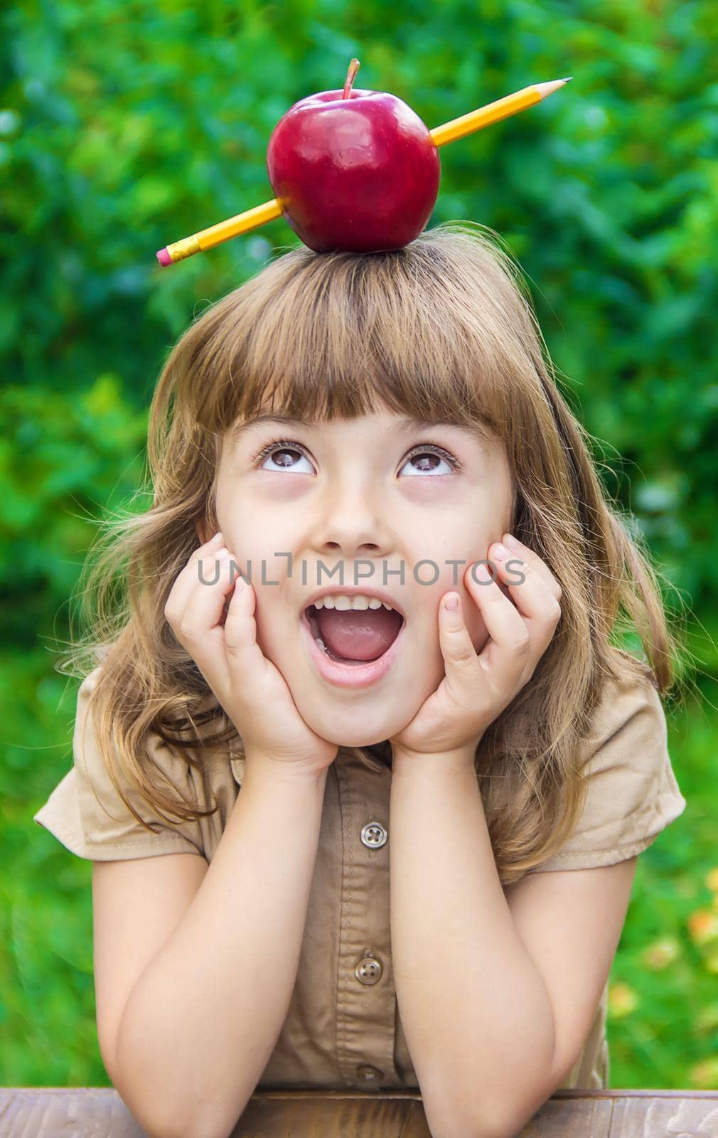 little girl student with a red apple. Selective focus. nature. nature.
