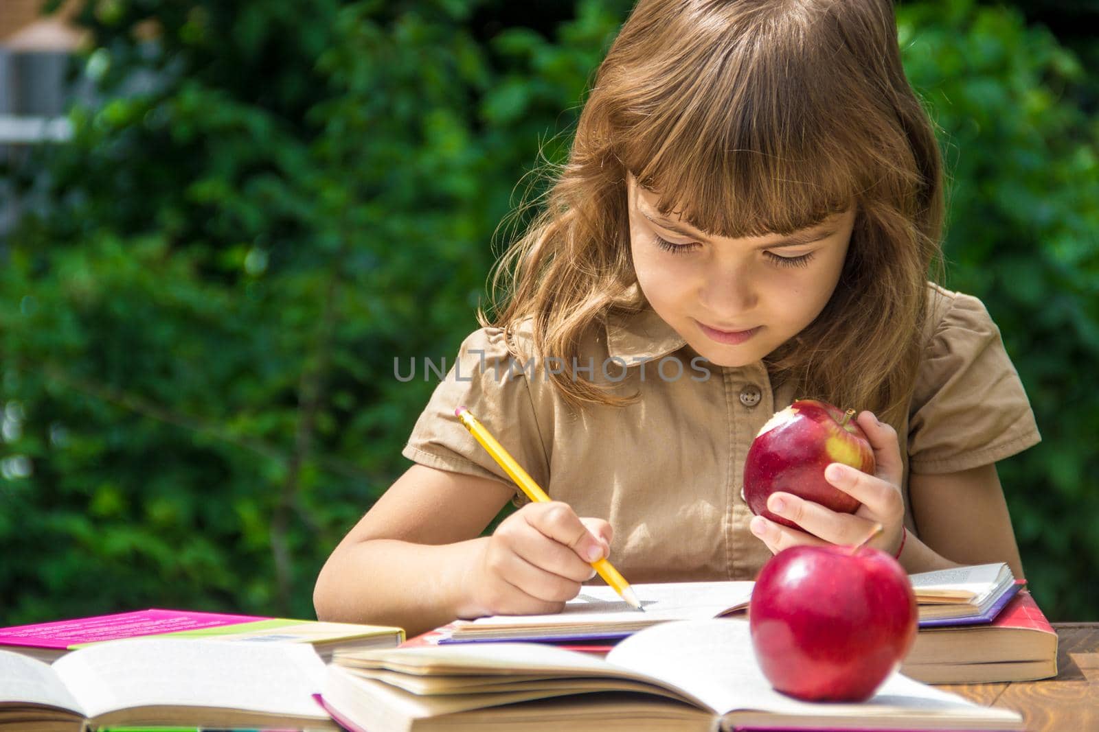 Child student with a red apple. Selective focus. nature.