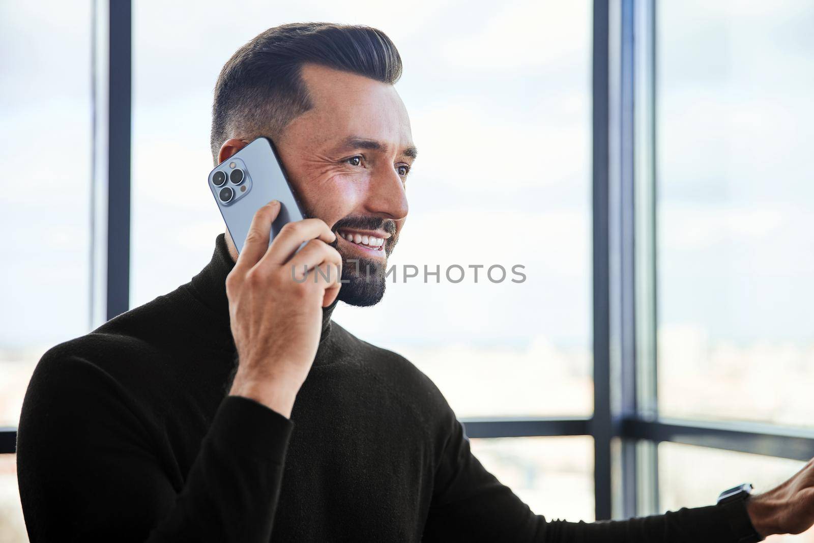 man in a protective mask talking on a smartphone by SmartPhotoLab