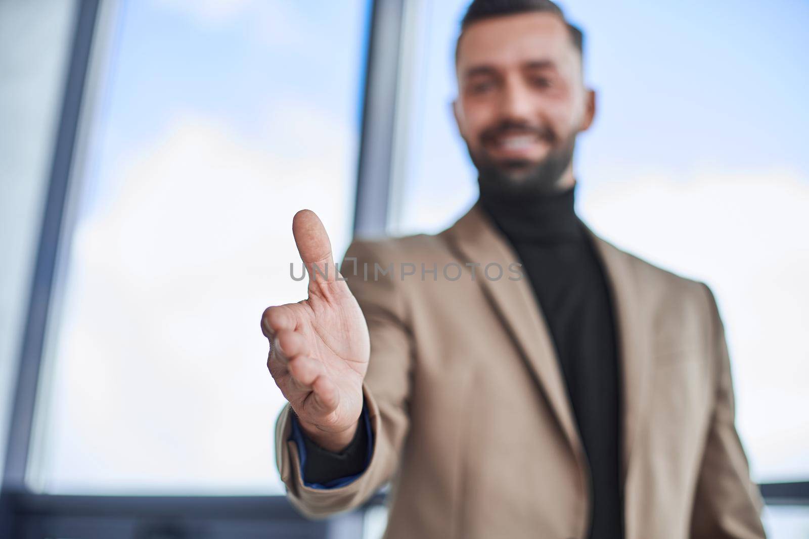 close up. business man offering his handshake. by SmartPhotoLab