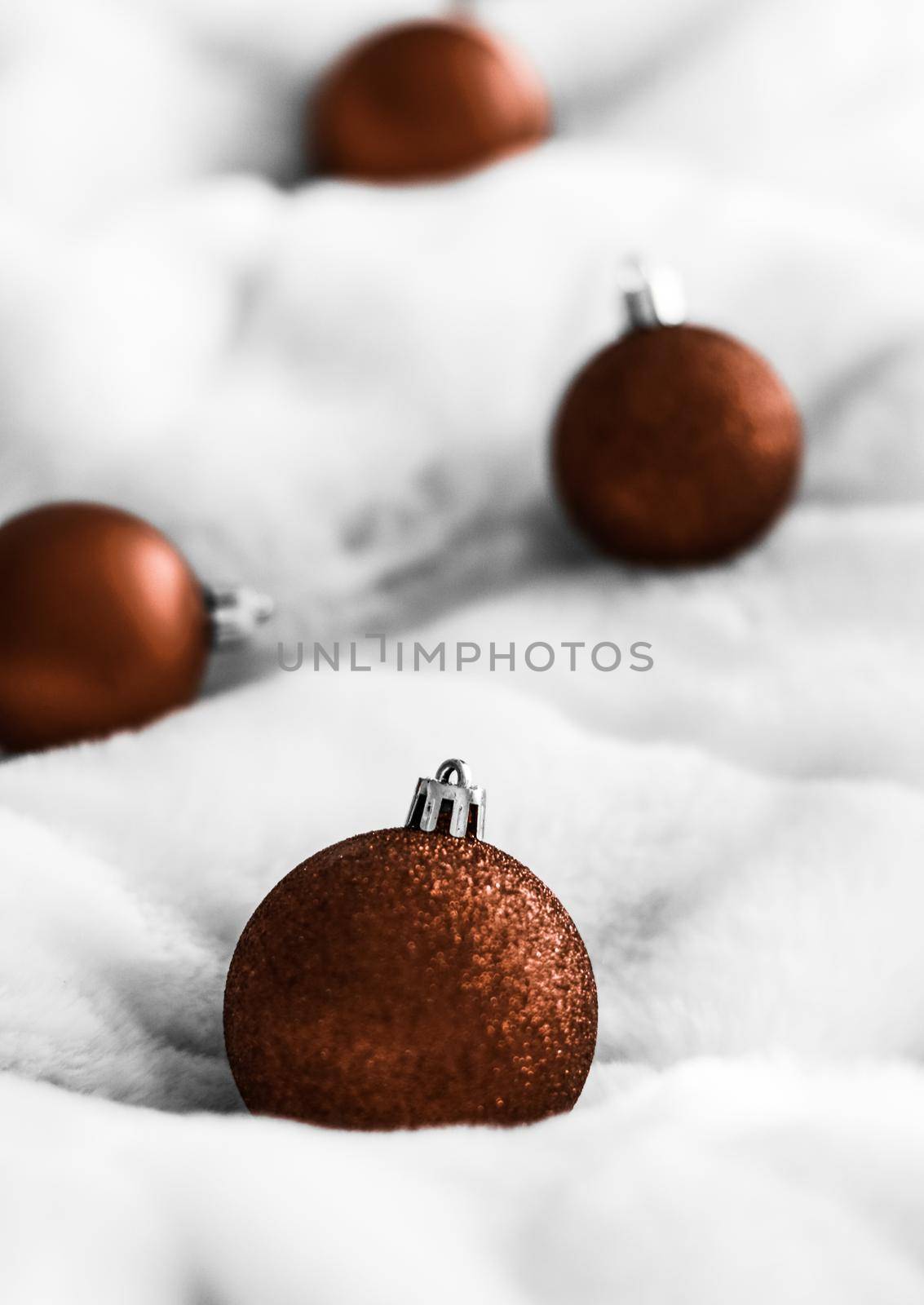 Gift decor, New Years Eve and happy celebration concept - Chocolate brown Christmas baubles on white fluffy fur backdrop, luxury winter holiday design background