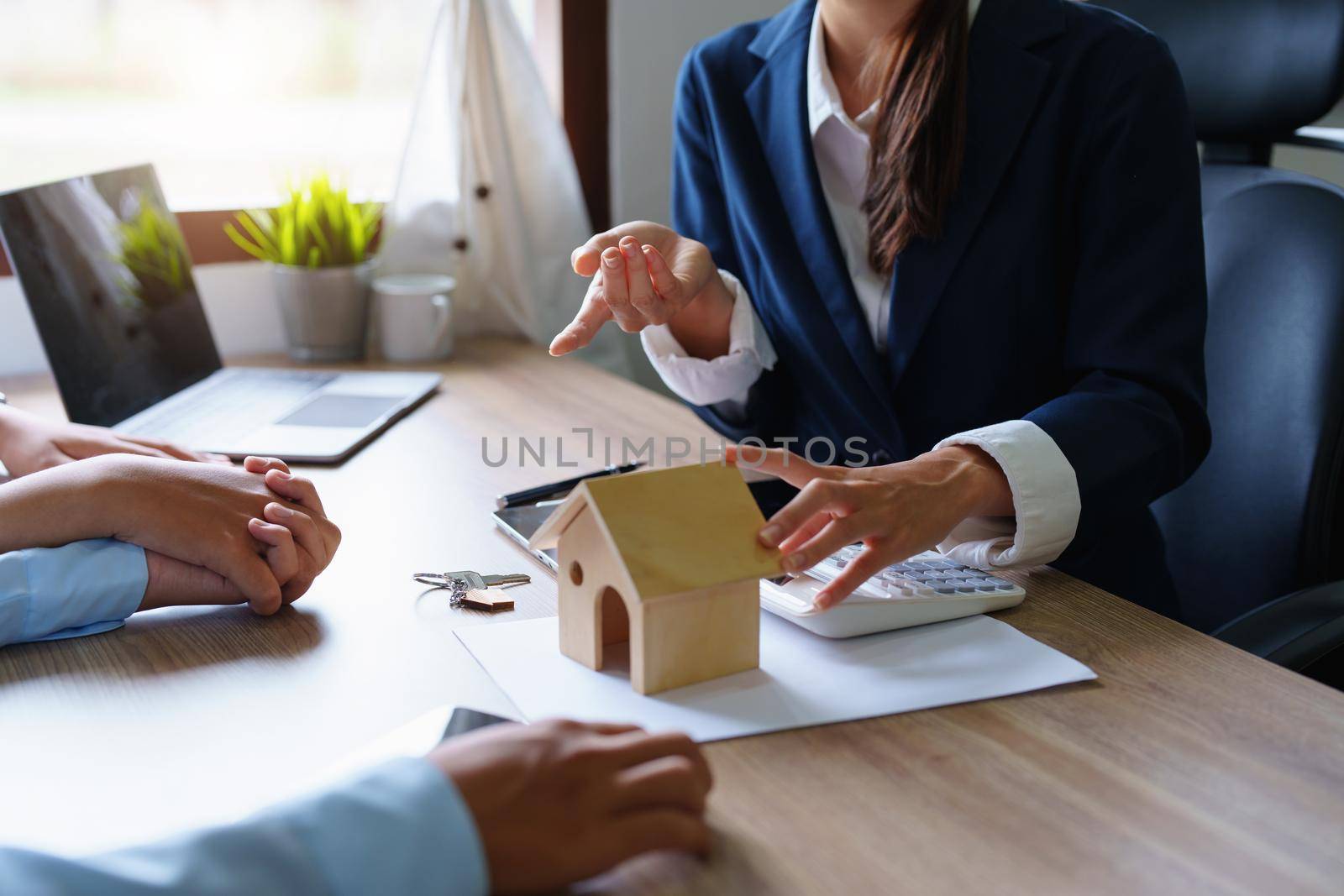 Portrait of a real estate agent or bank officer, the lending department quotes the interest on the loan to the customer to assess the risk of investing in a home by Manastrong