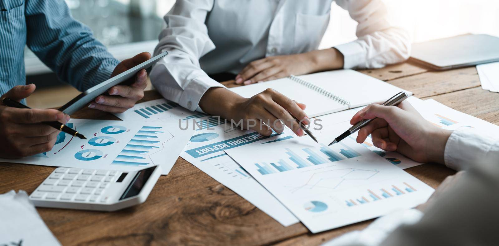 Businesspeople analyzing investment graph meeting brainstorming and discussing plan in meeting room, investment concept.