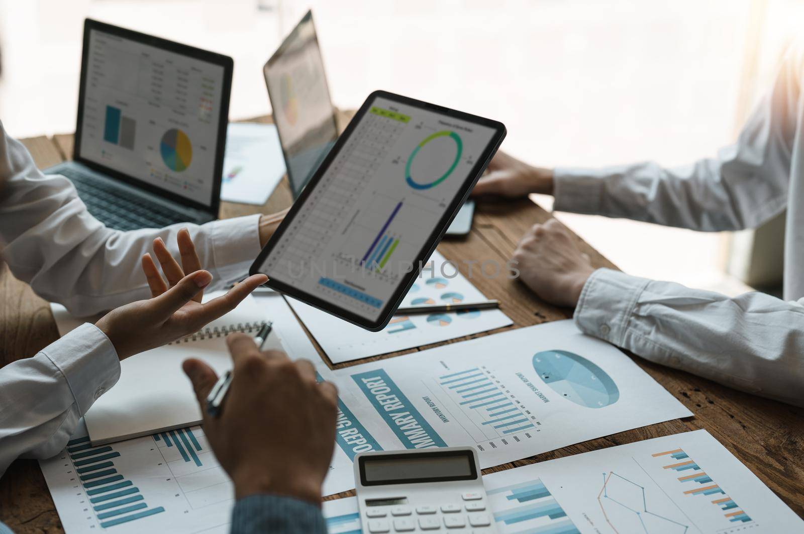 Business people are meeting for analysis data figures to plan business strategies. Business discussing concept.