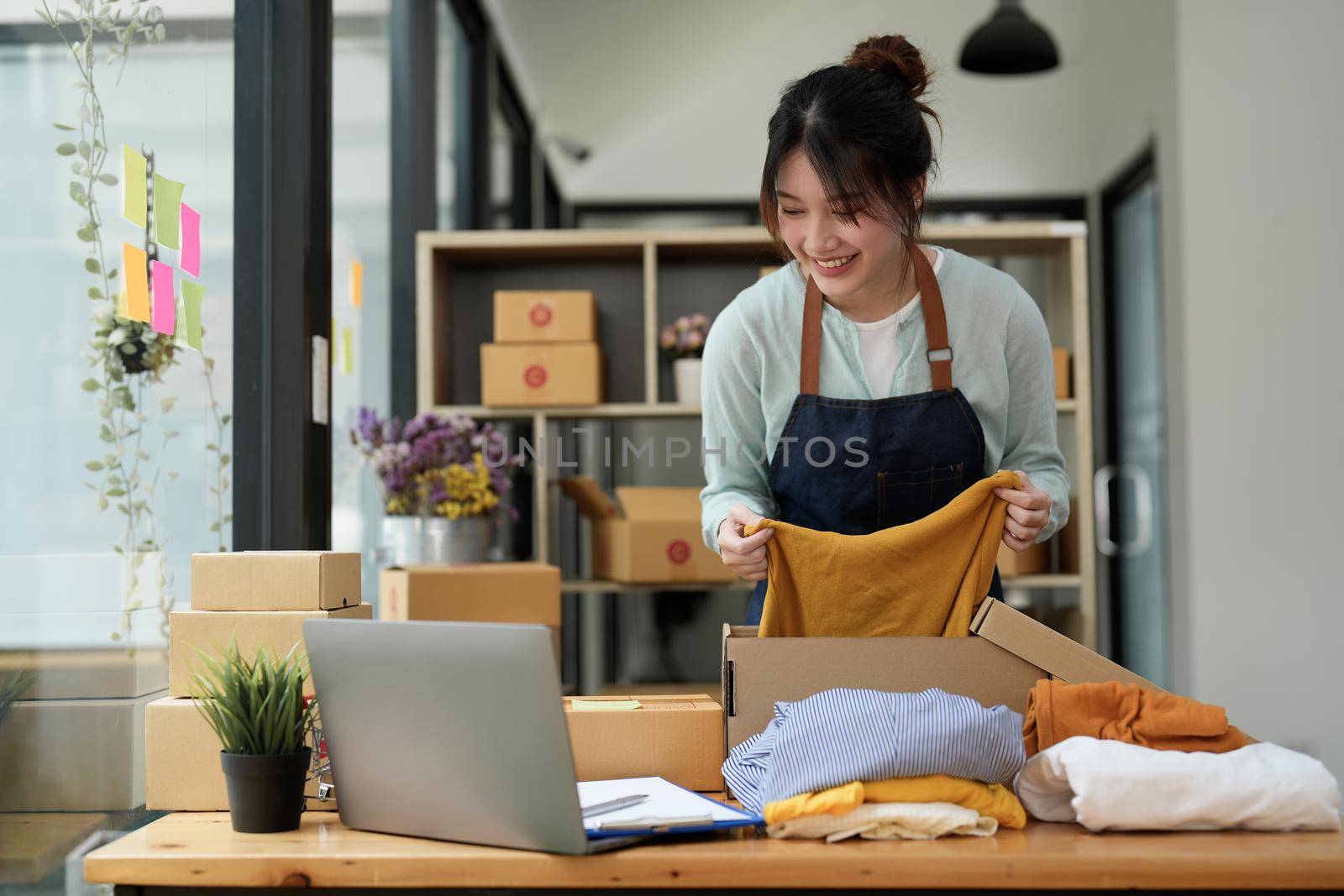 Young asian startup entrepreneur small business owner working at home, packaging and delivery situation