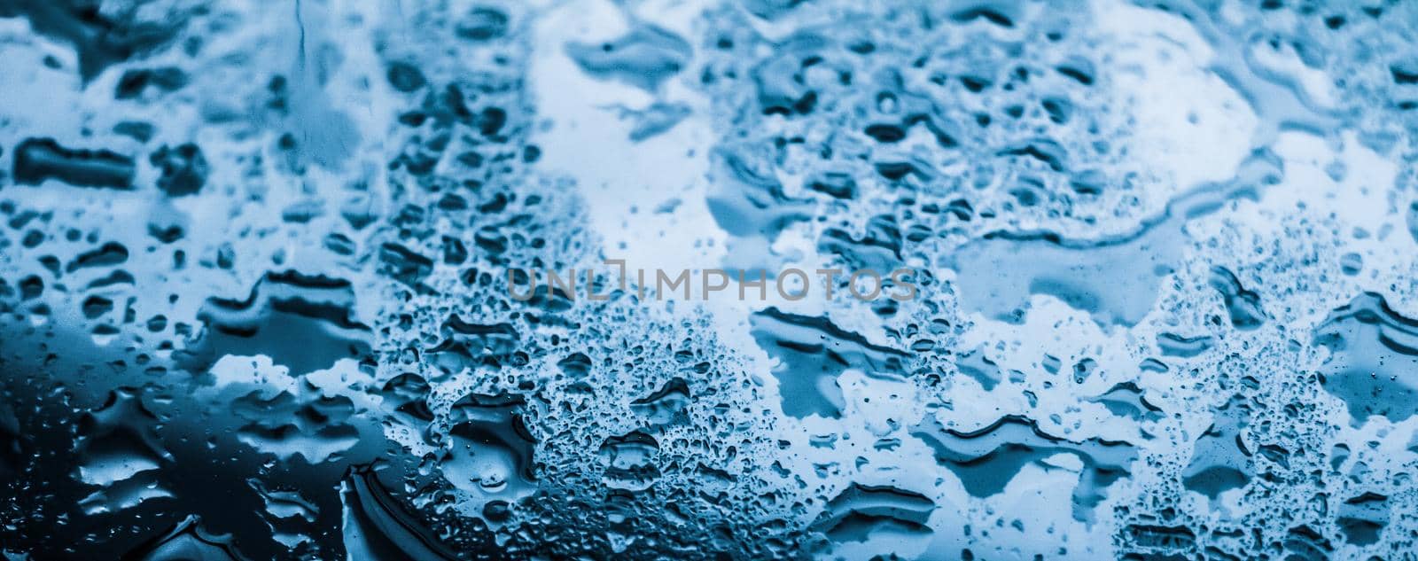 Liquid, wet and zen concept - Water texture abstract background, aqua drops on blue glass as science macro element, rainy weather and nature surface art backdrop for environmental brand design