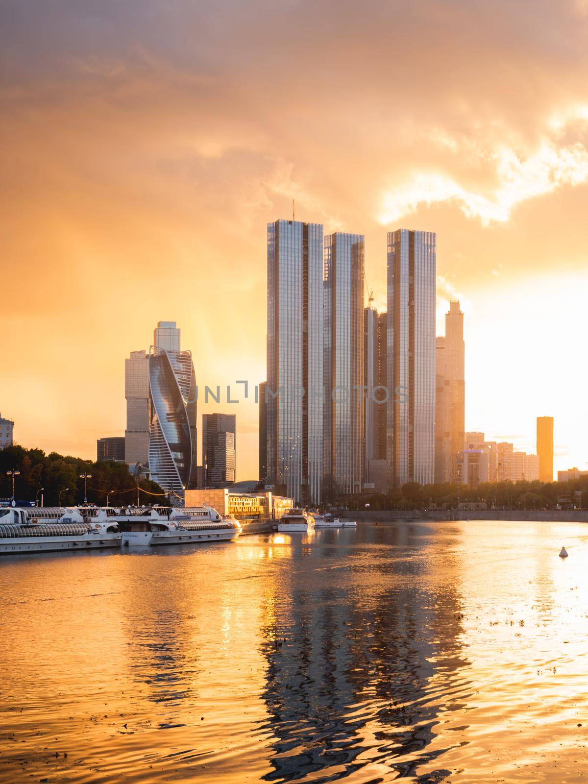 MOSCOW, RUSSIA - September 17, 2022. Gorgeous orange sunset of Capital Towers and Moscow City Business Center on Moscow-river embankment.