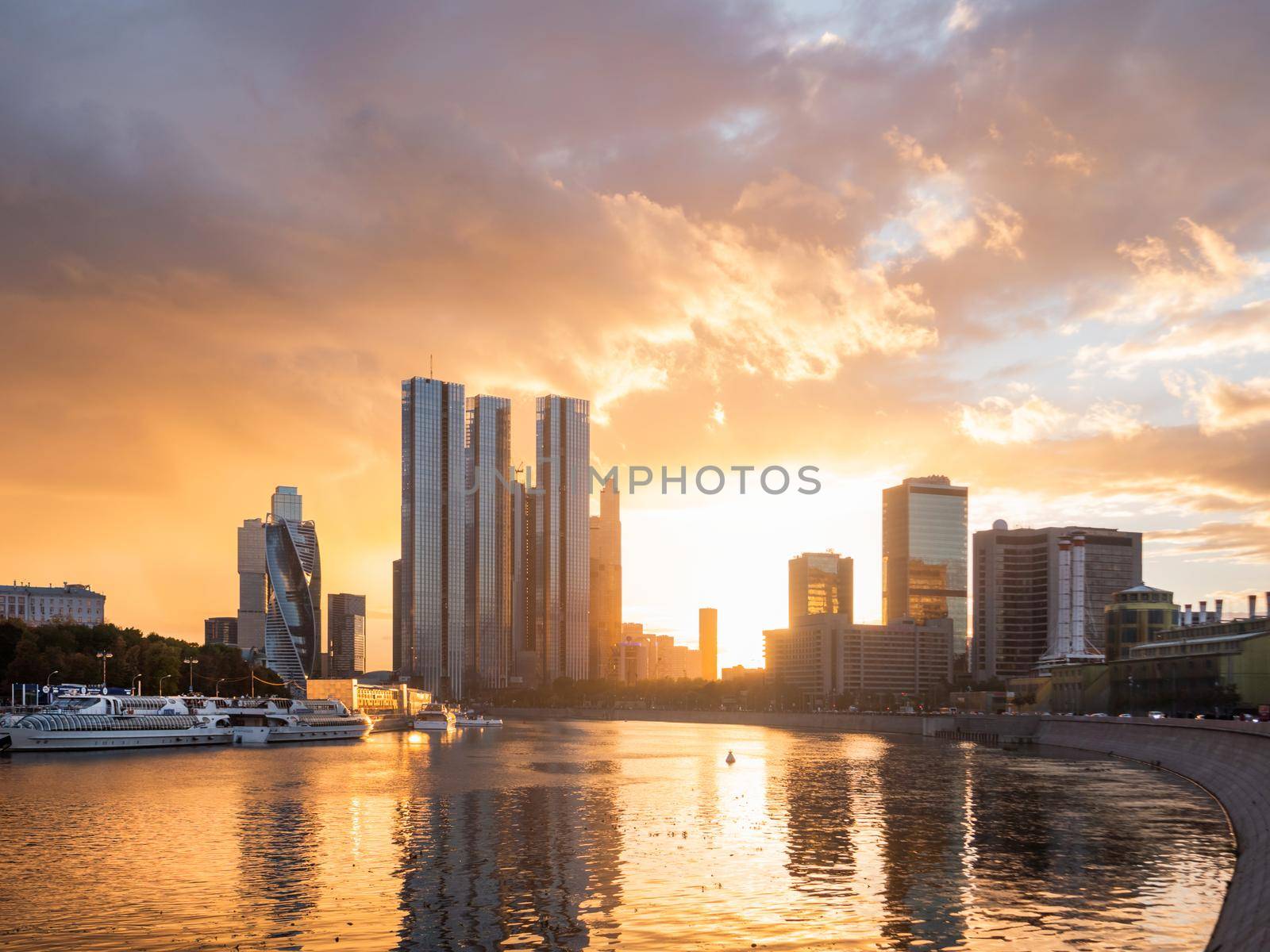 MOSCOW, RUSSIA - September 17, 2022. Gorgeous orange sunset of Capital Towers and Moscow City Business Center on Moscow-river embankment. by aksenovko