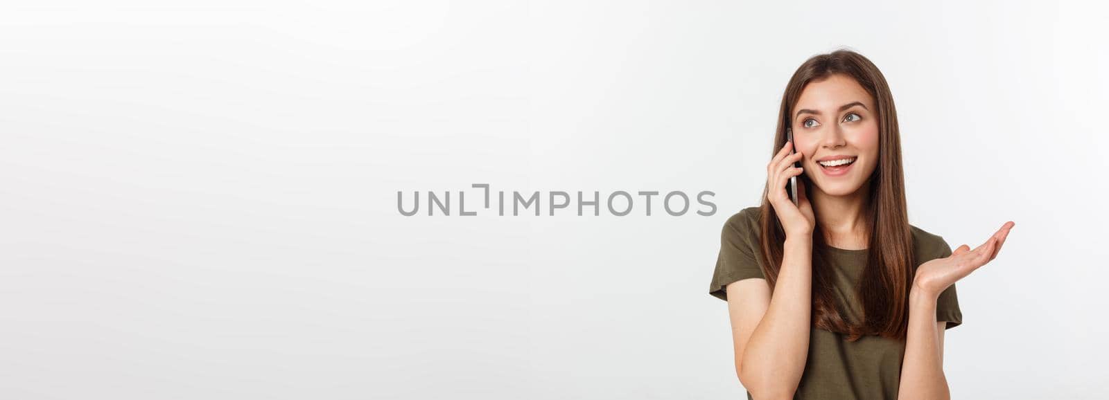 Laughing woman talking and texting on the phone isolated on a white background