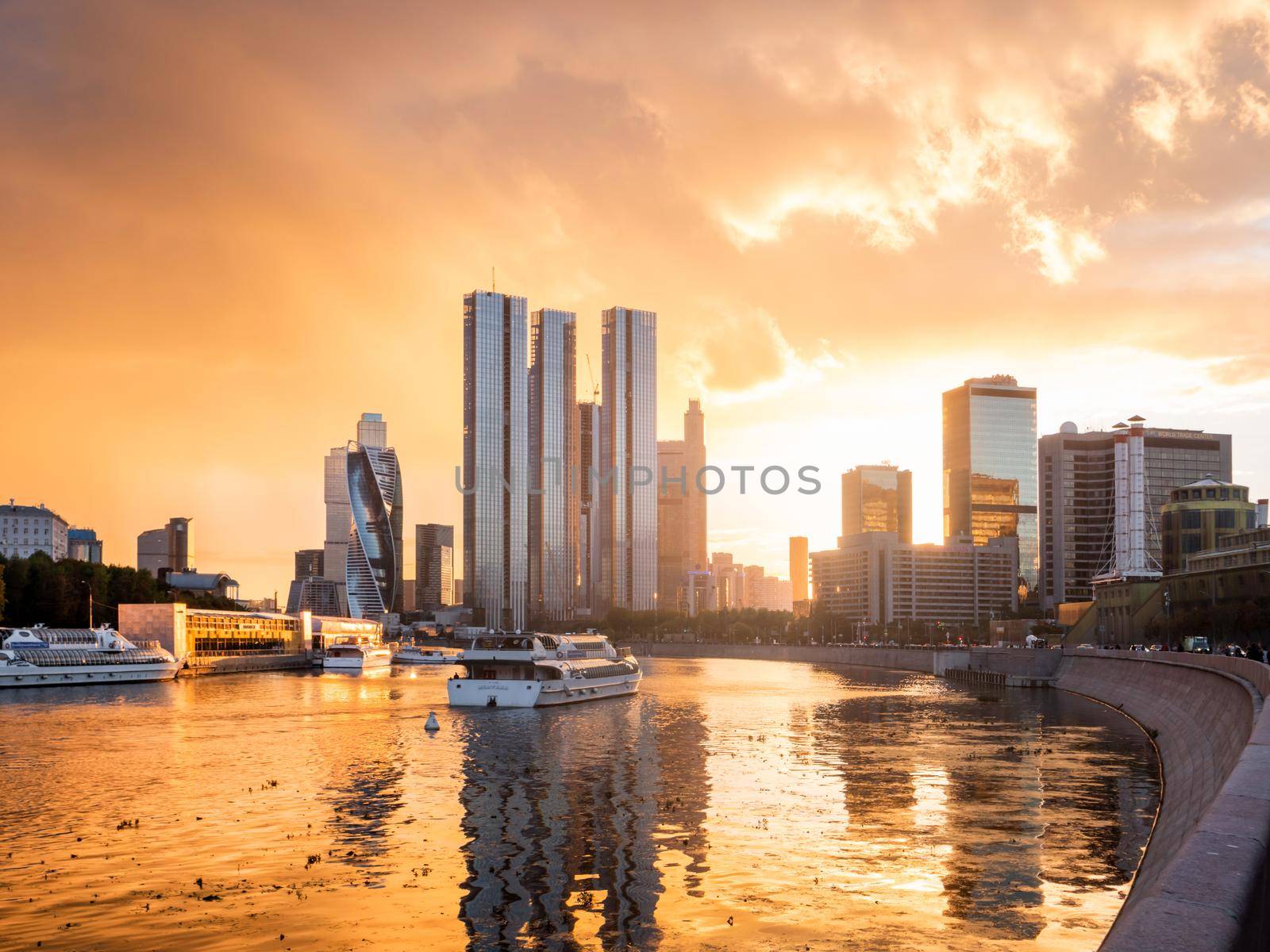 MOSCOW, RUSSIA - September 17, 2022. Gorgeous orange sunset of Capital Towers and Moscow City Business Center on Moscow-river embankment.