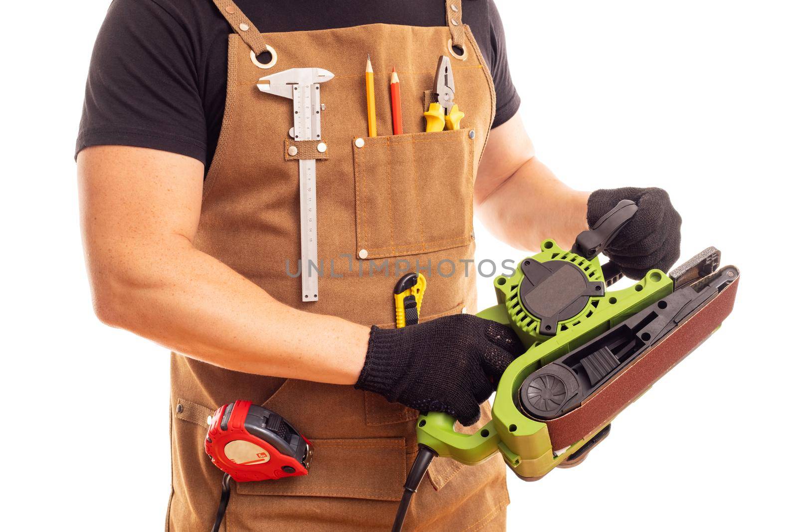 Carpenter in workers apron holding belt electric sander isolated on white background.