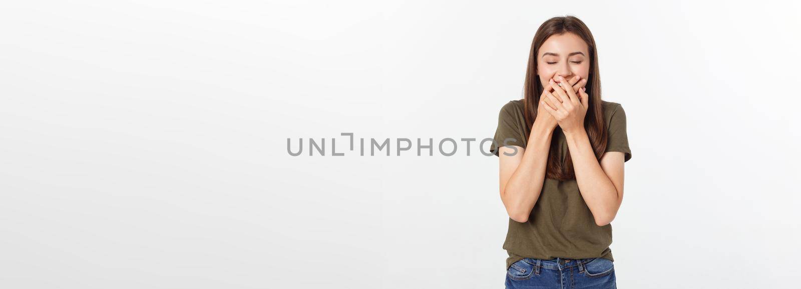 Happy woman laughing covering her mouth with a hands isolate over grey background