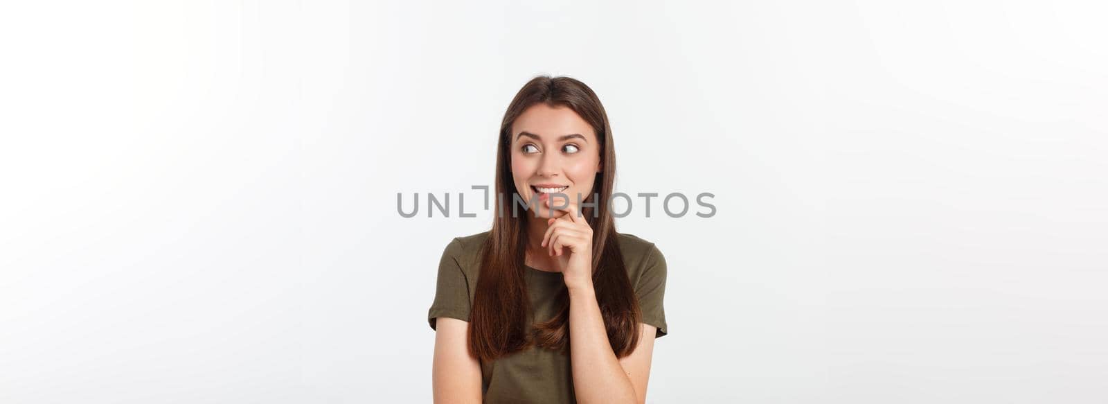 amazement - woman excited looking to the side. Surprised happy young woman looking sideways in excitement. Mixed race Asian and white Caucasian female model on grey background