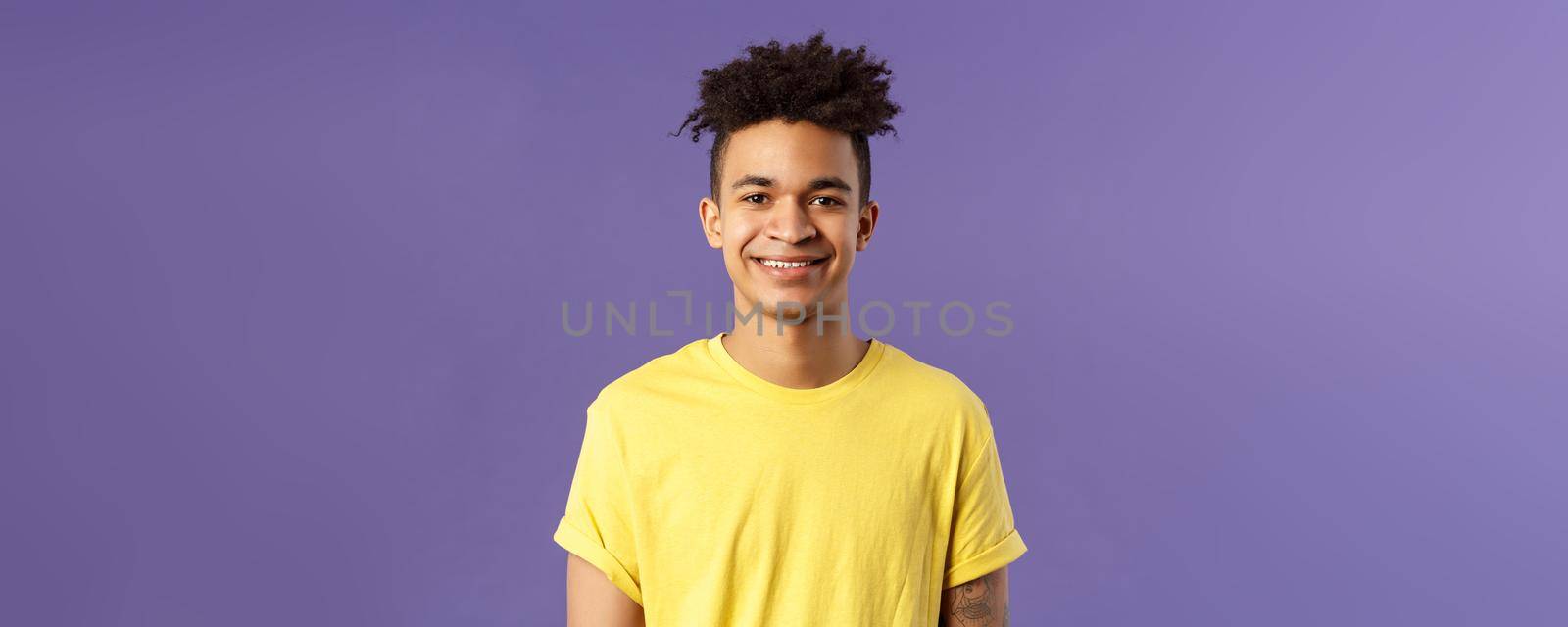 Close-up portrait of smiling, enthusiastic hispanic male student searching job, consider career opportunities, recruiting to company, smiling cheerful standing purple background by Benzoix