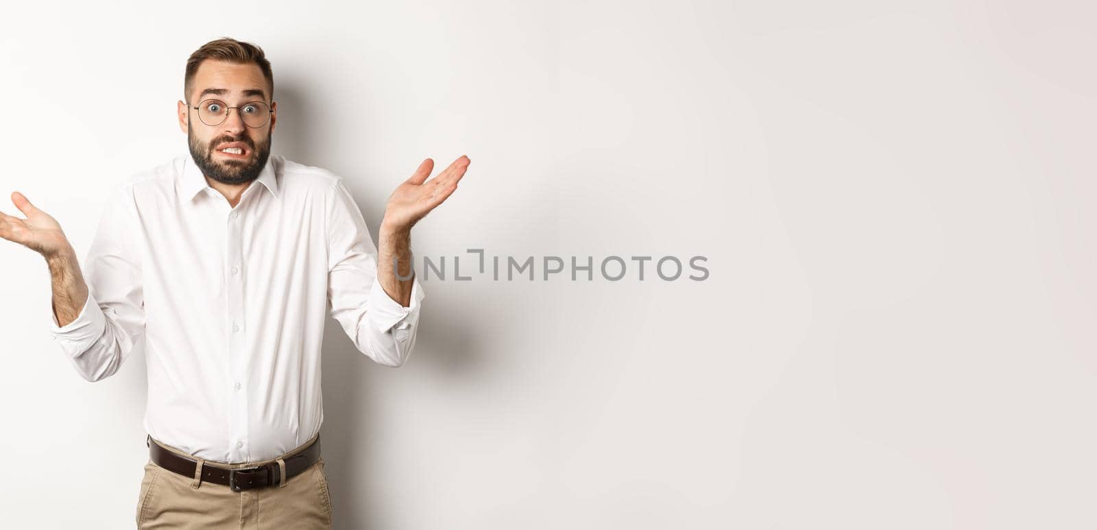 Clueless worried manager shrugging, looking confused, standing over white background by Benzoix