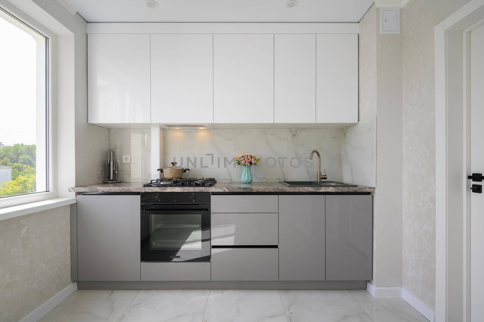 White and grey small modern domestic kitchen interior and furniture
