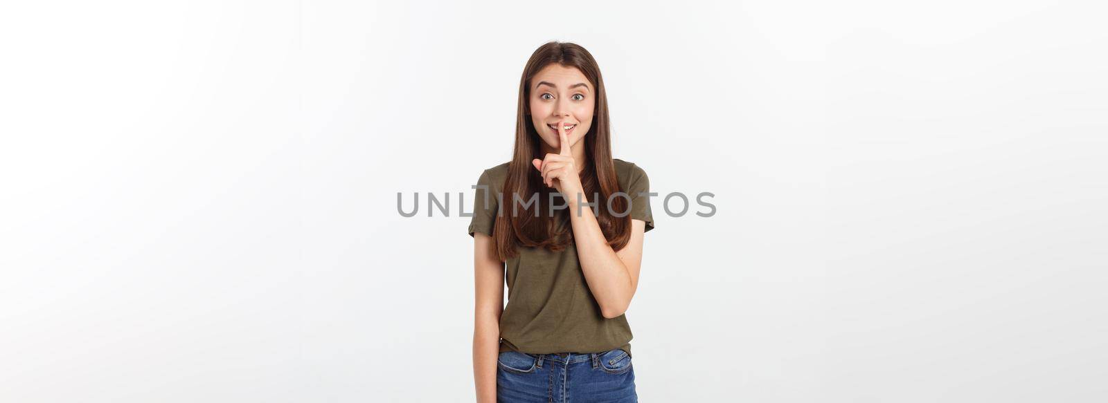 Beautiful woman showing finger over lips isolated on a white background. by Benzoix