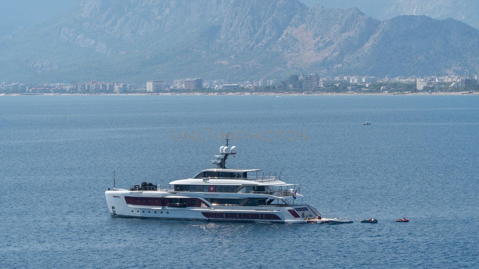Yacht in the sea against the backdrop of mountains and the city by voktybre