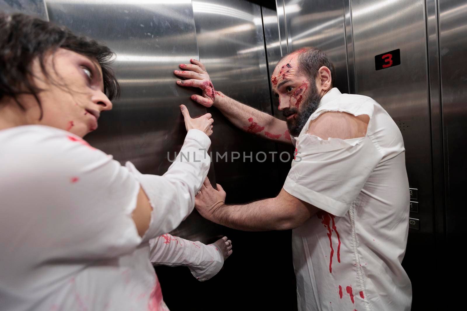 Aggressive evil zombies trying to escape elevator, brain eating evil monsters attacking workplace. Creepy spooky undead walkers with bloody dirty wounds, looking scary and gory terrifying.