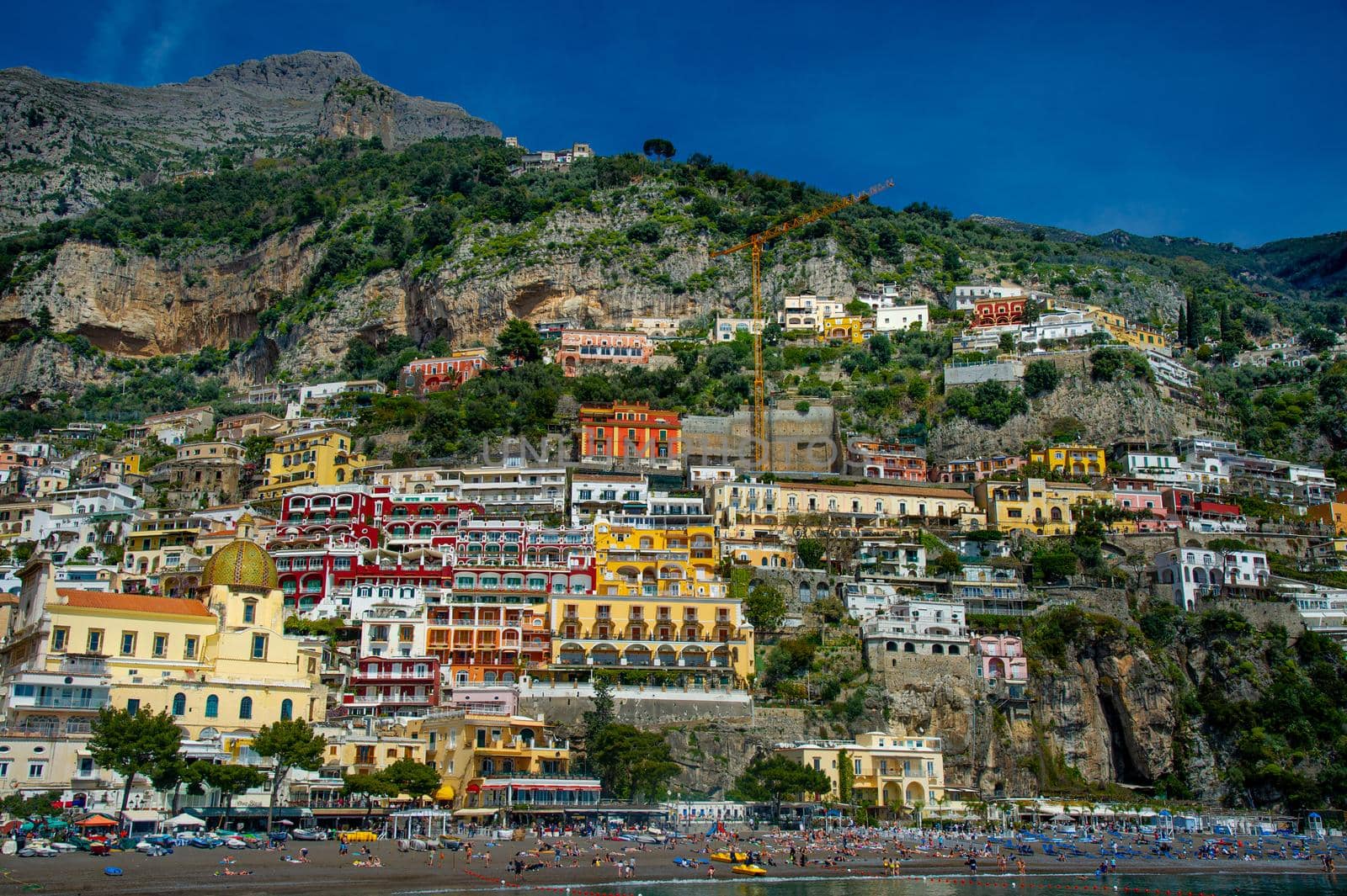 Amalfi Coast Italy photographed from the ferryboat on a sunny day with colourful houses visible on the coast 2022 april 15