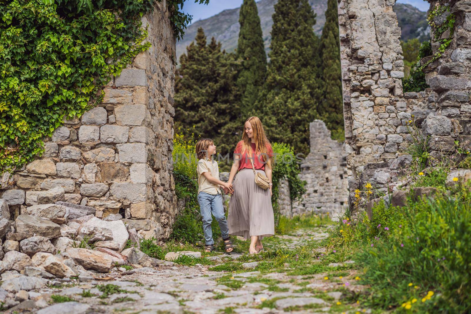 Mom and son tourists walks through the old town of Bar in Montenegro. Happy tourist walks in the mountains. Suburbs of the city of Bar, Montenegro, Balkans. Beautiful nature and landscape.