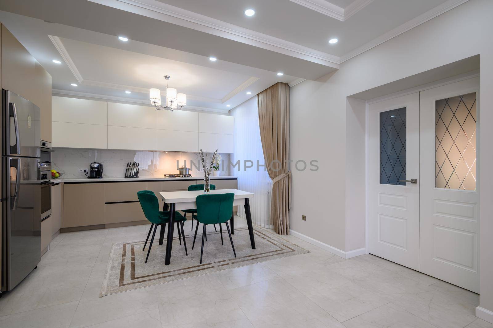 Modern classic white and beige luxurious kitchen with dining room in studio apartment interior