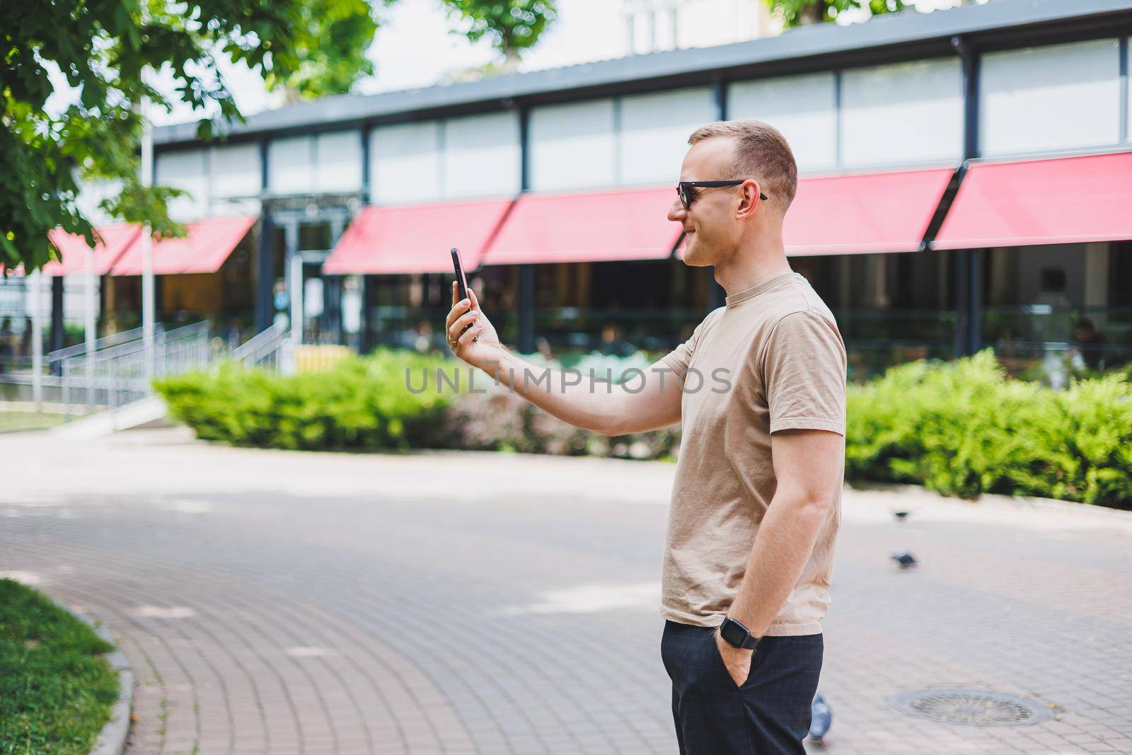 Man in shopping. Smiling man with shopping bags walking down the street. Consumerism, lifestyle concept