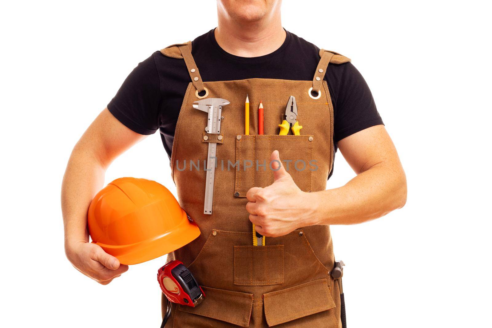 Contractor worker or carpenter in workers apron with tools and helmet holding thumbs up isolated on white background.