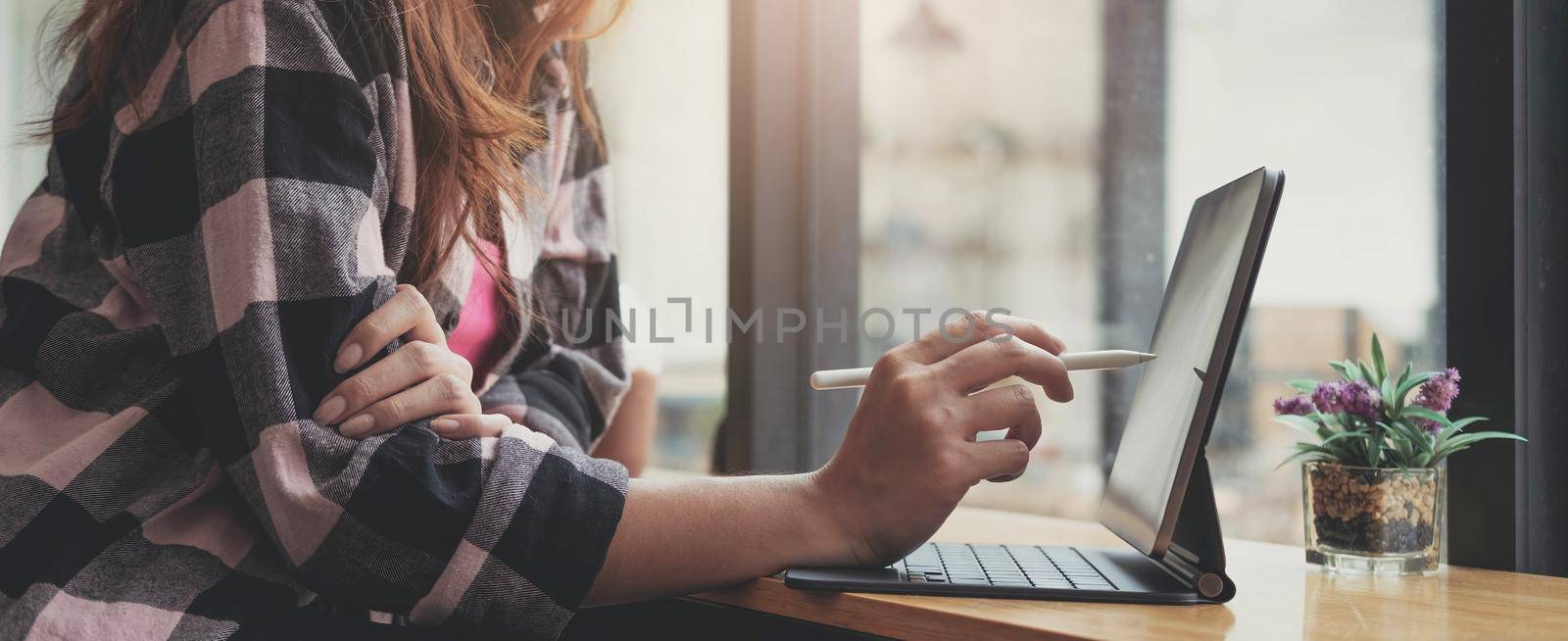 Close up of woman working By typing on the laptop keyboard at the office by wichayada