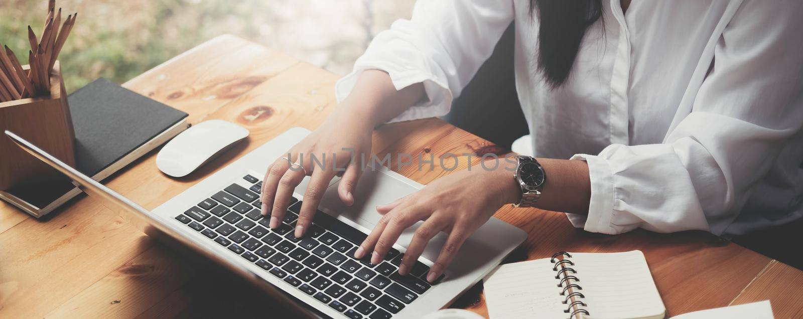 Close up of businesswoman working By typing on the laptop keyboard at the office.