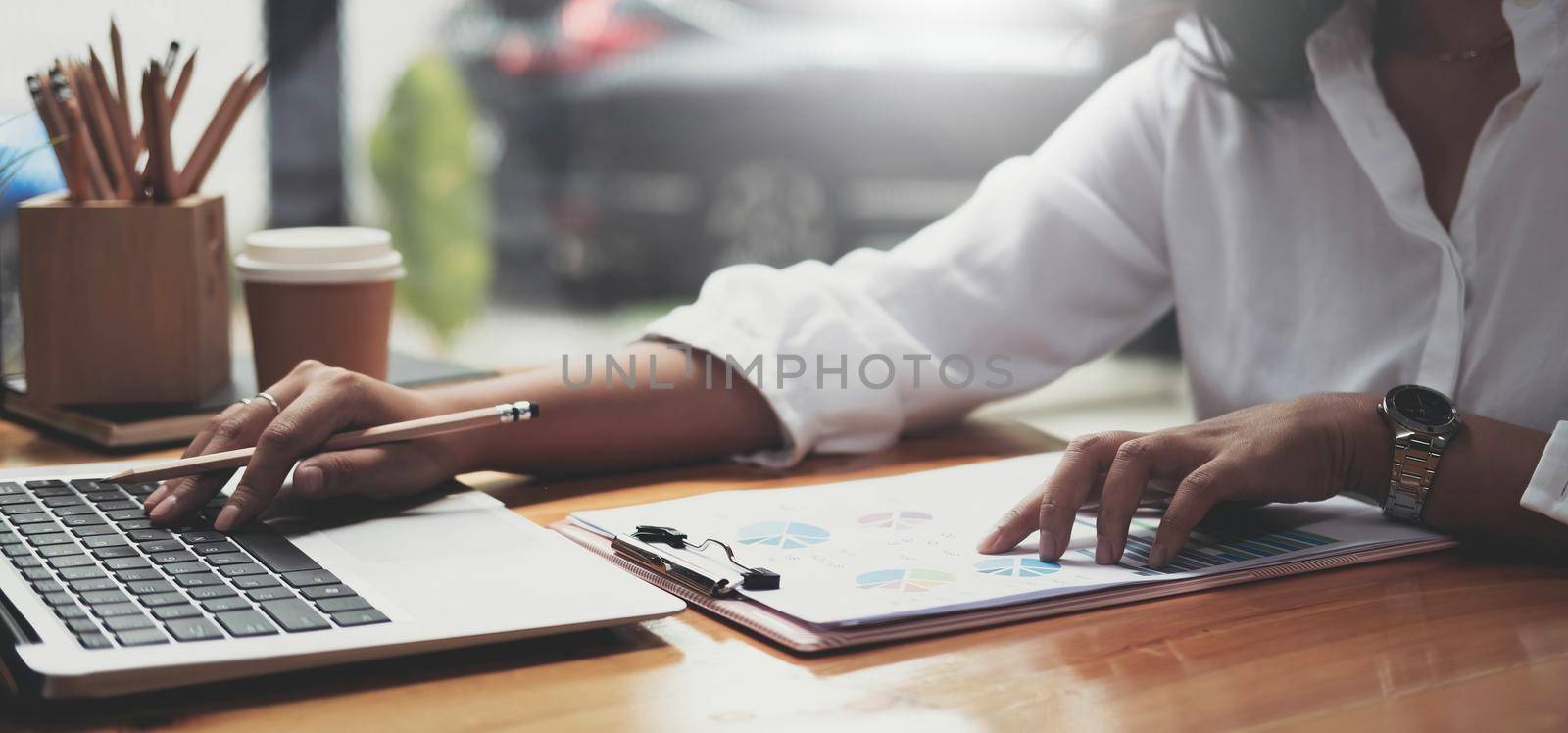 closeup woman working financial report with laptop computer at