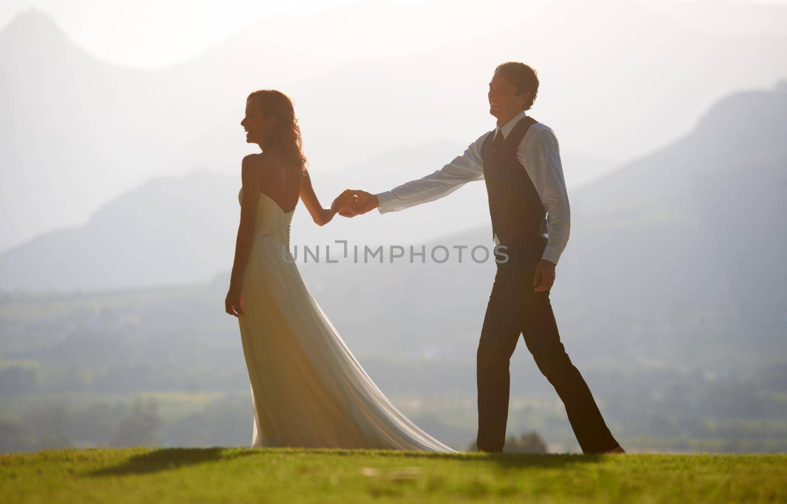 Take my hand. A beautiful bride and groom walking hand in hand