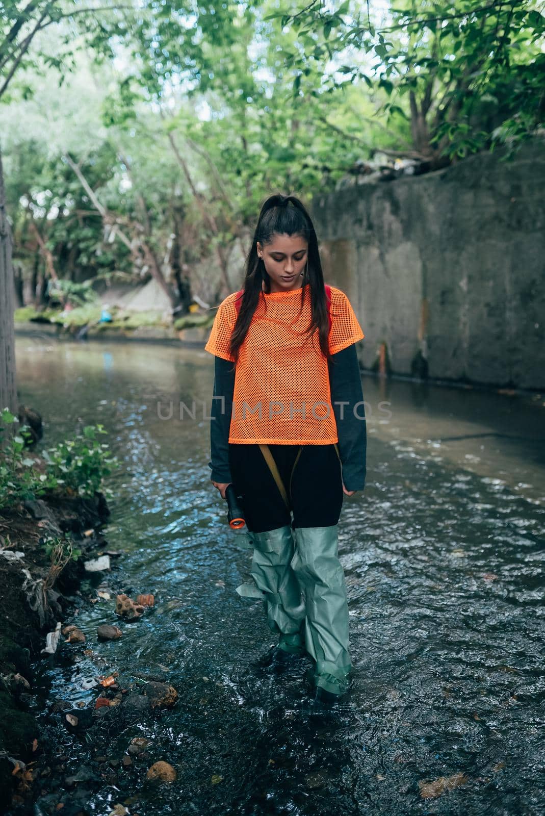 A young female digger walks along a rain collector