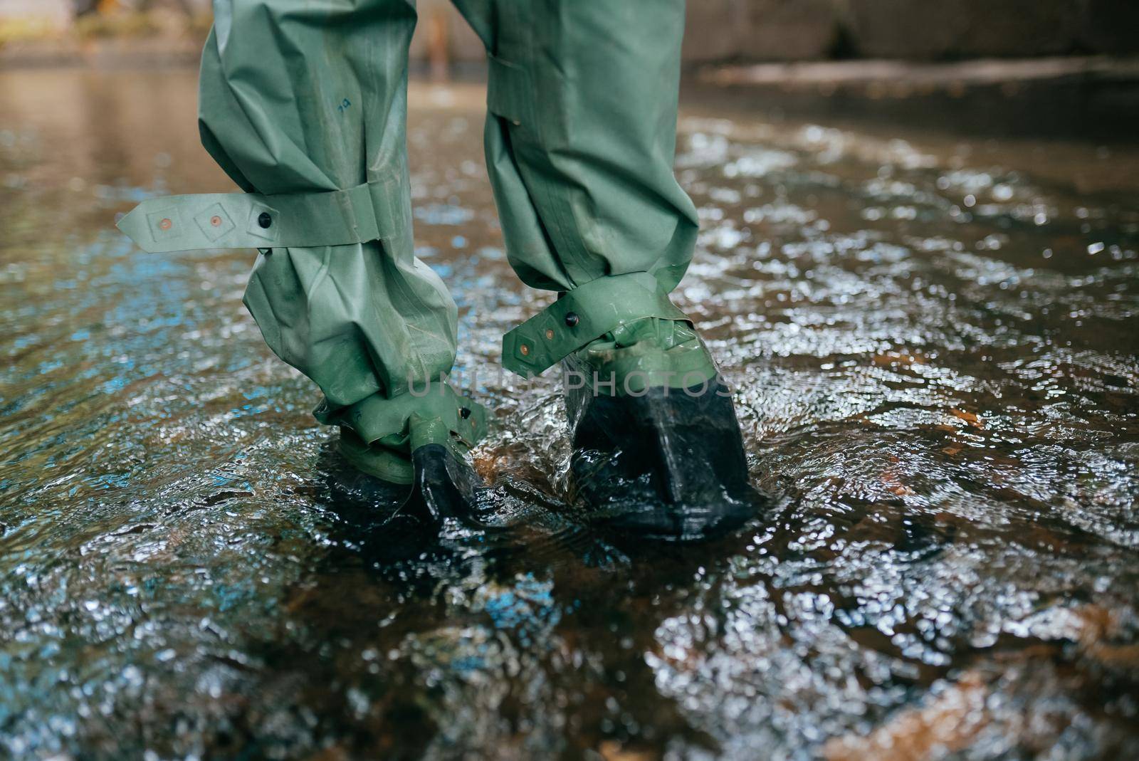 Close up view of waterproof pants boots in water