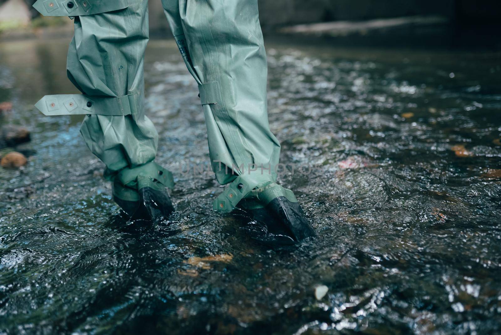 Close up view of waterproof pants boots in water