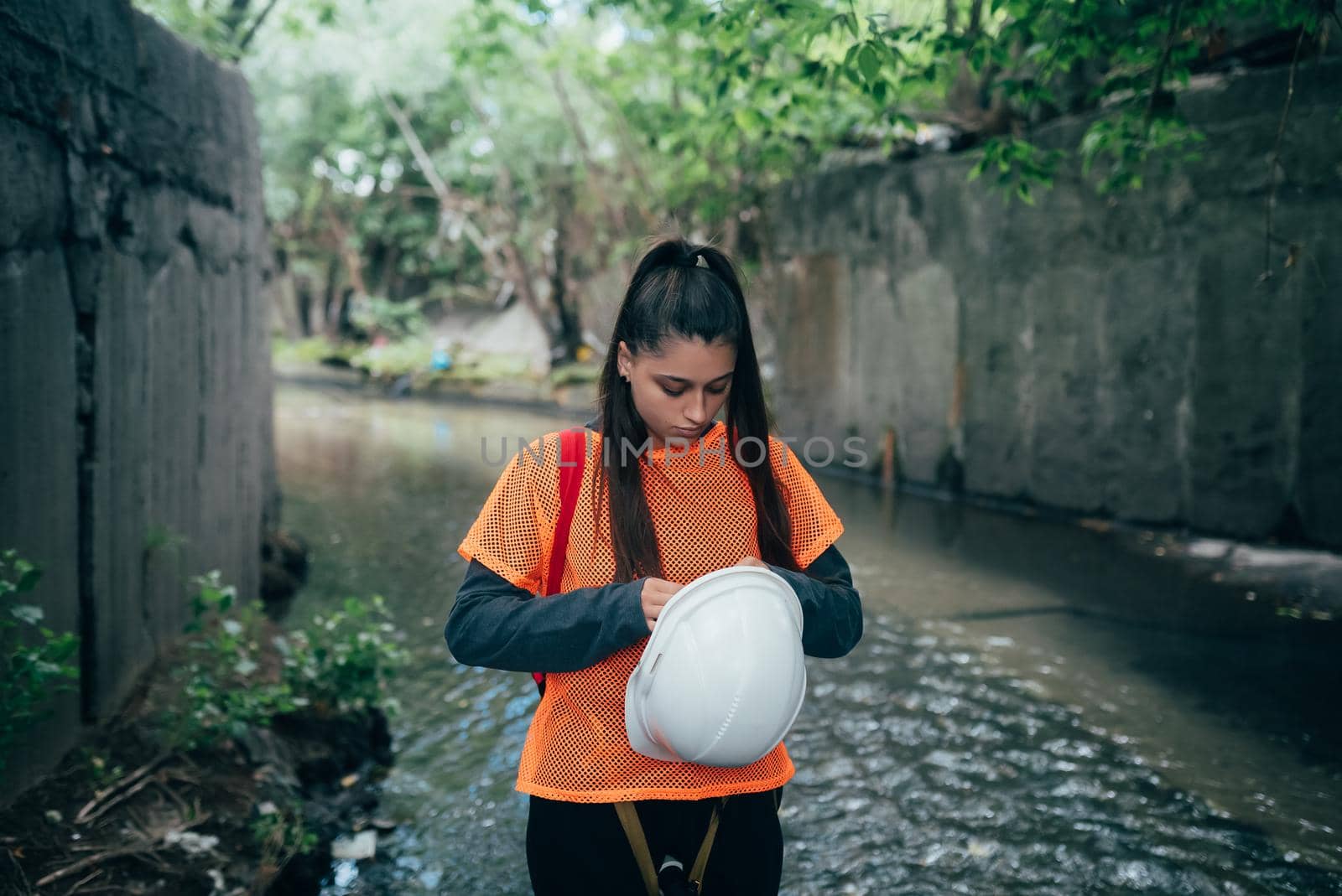 A young female digger walks along a rain collector