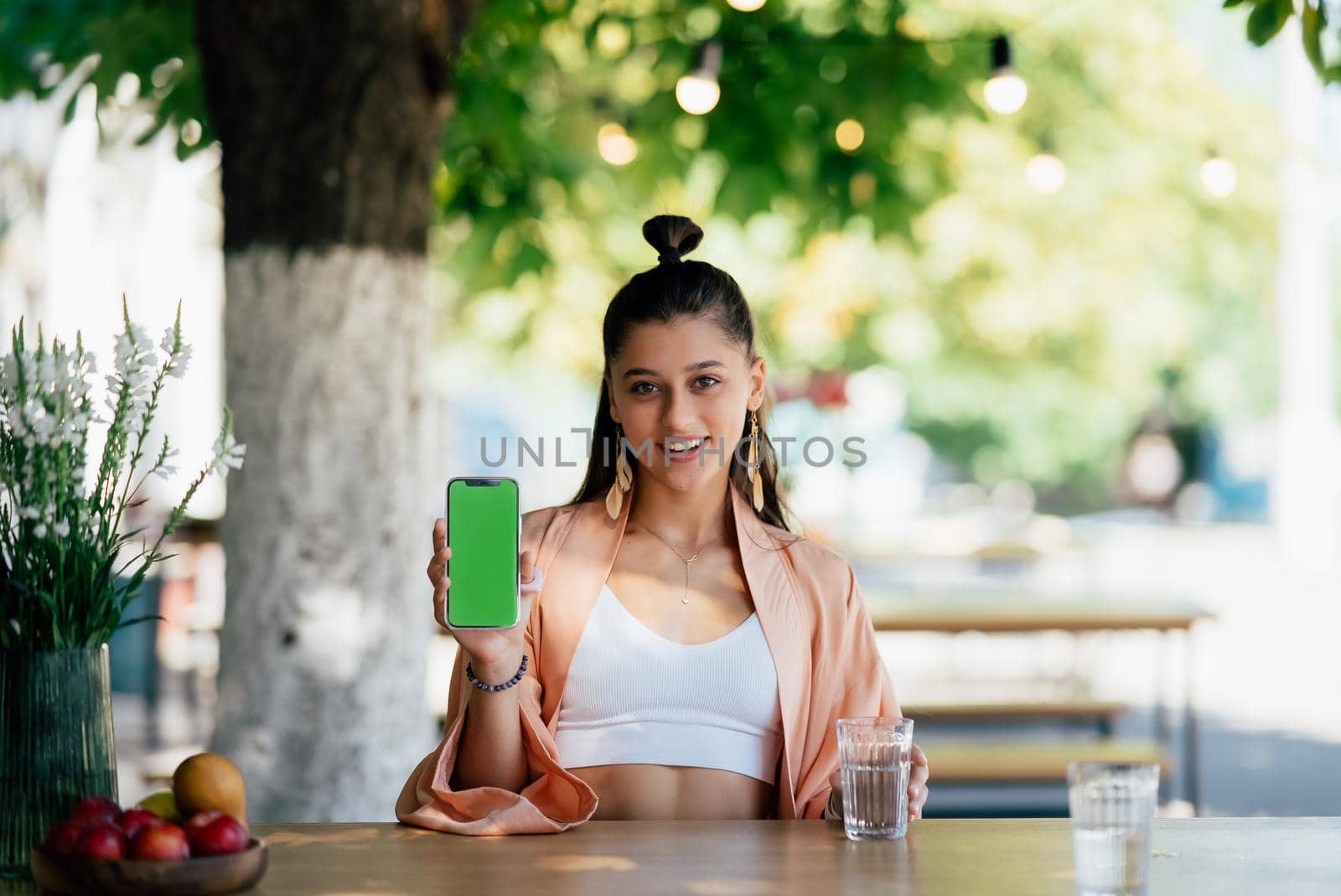 Happy woman hold smartphone. Green screen phone screen