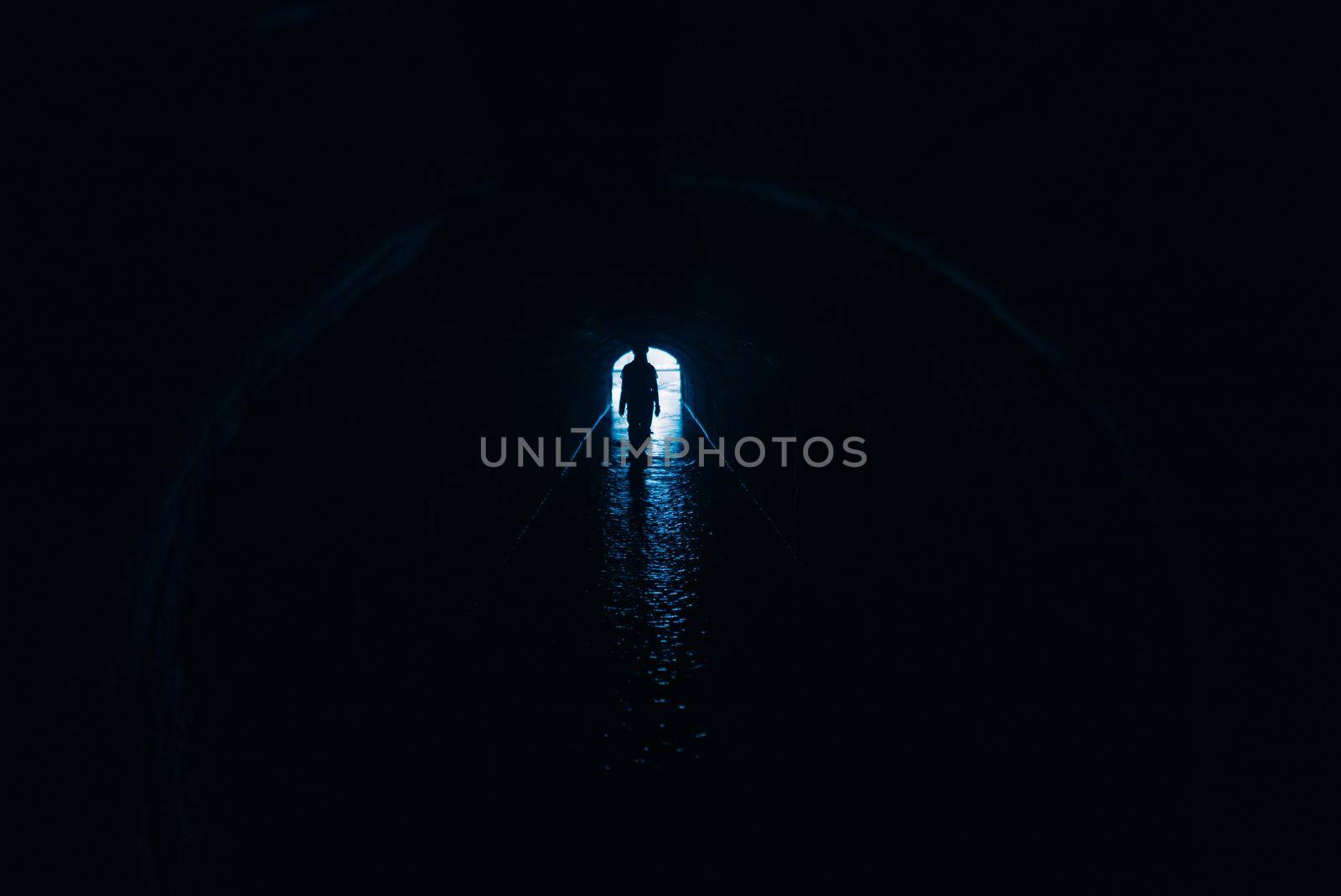 Silhouette of a woman in a tunnel. Exit