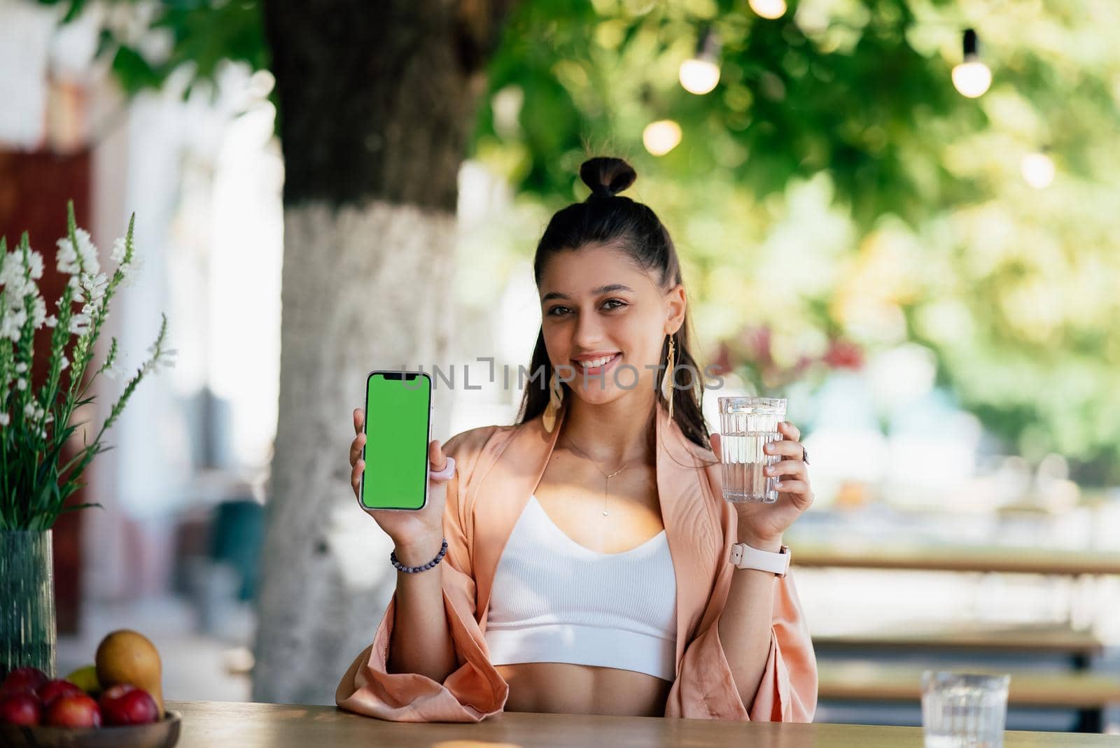 Happy woman hold smartphone. Green screen phone screen