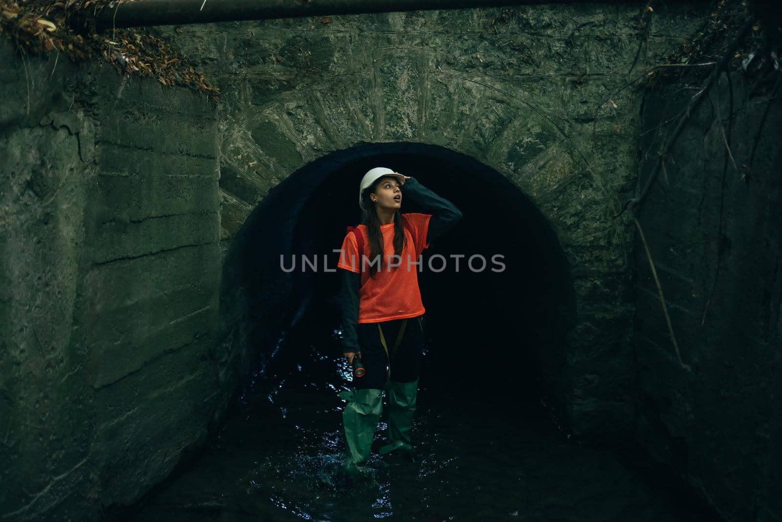 A young female digger walks along a rain collector