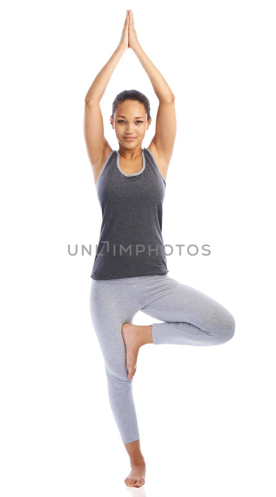 Yoga is calming and relaxing. A beautiful young woman doing a yoga pose against a white background. by YuriArcurs