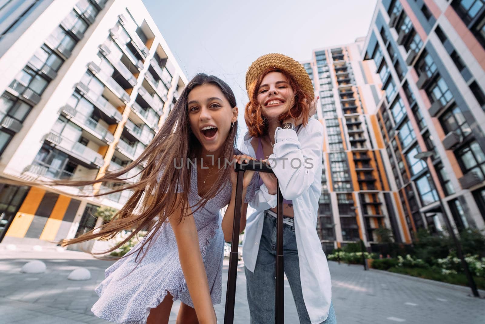Two women are looking at the camera on the street