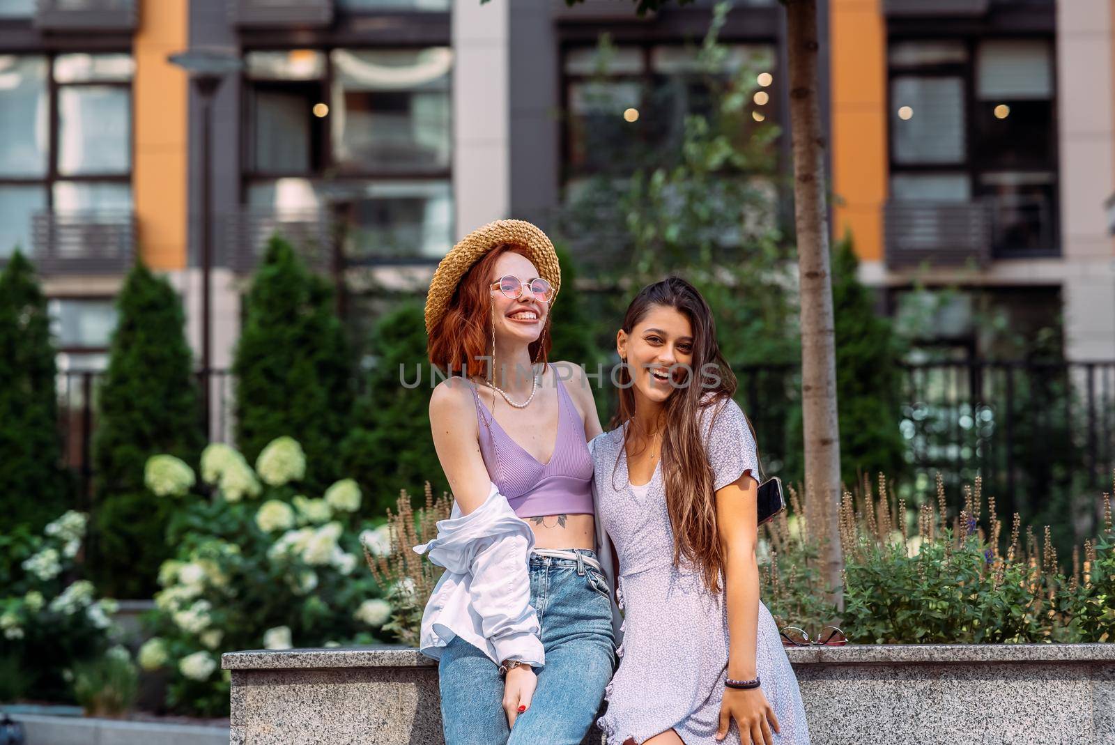 Two lovely girl friends hugging and having fun.