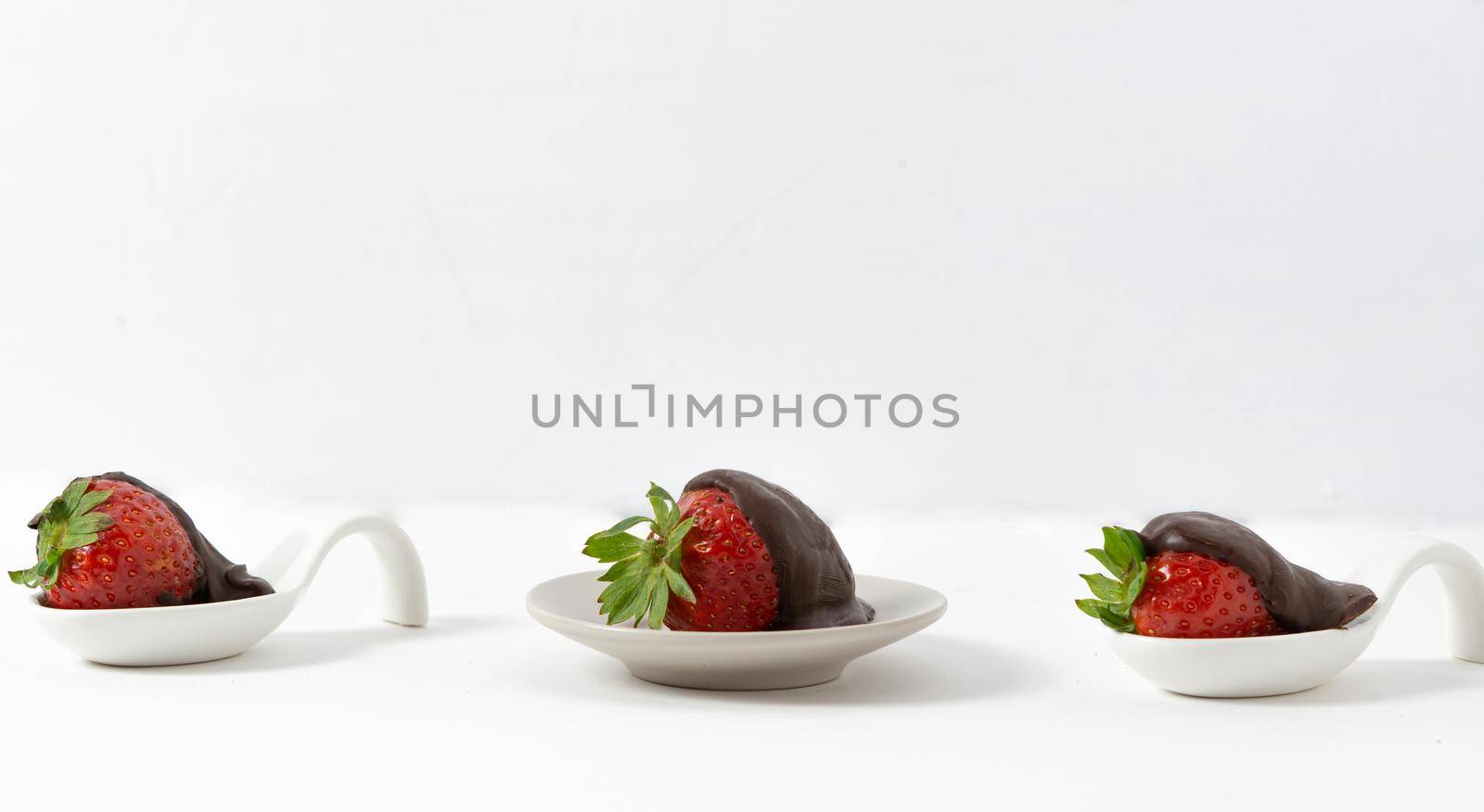 strawberries with chocolate on white background